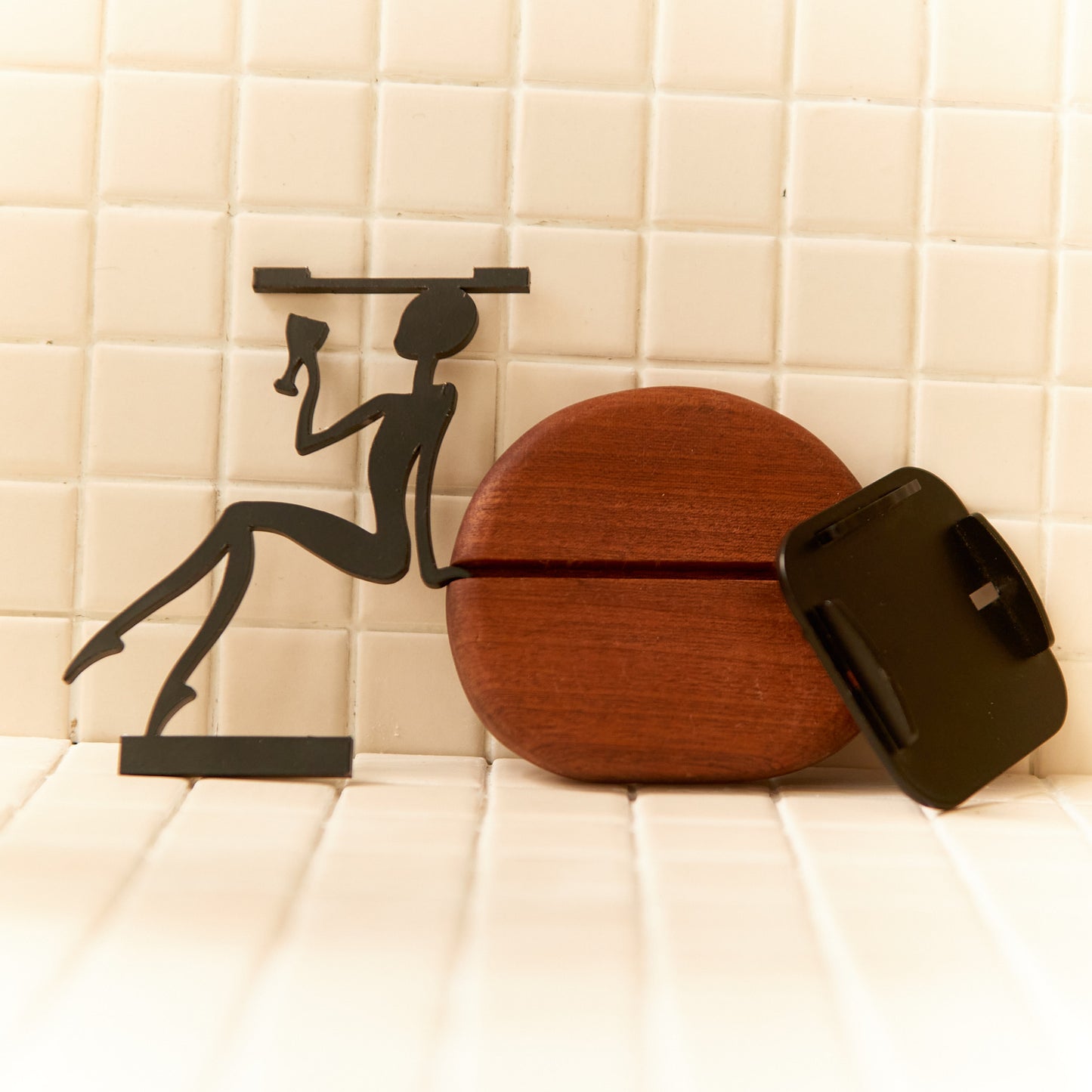 Modern alien decor figure lifting a wine glass, representing relaxation and humor in minimalist style.