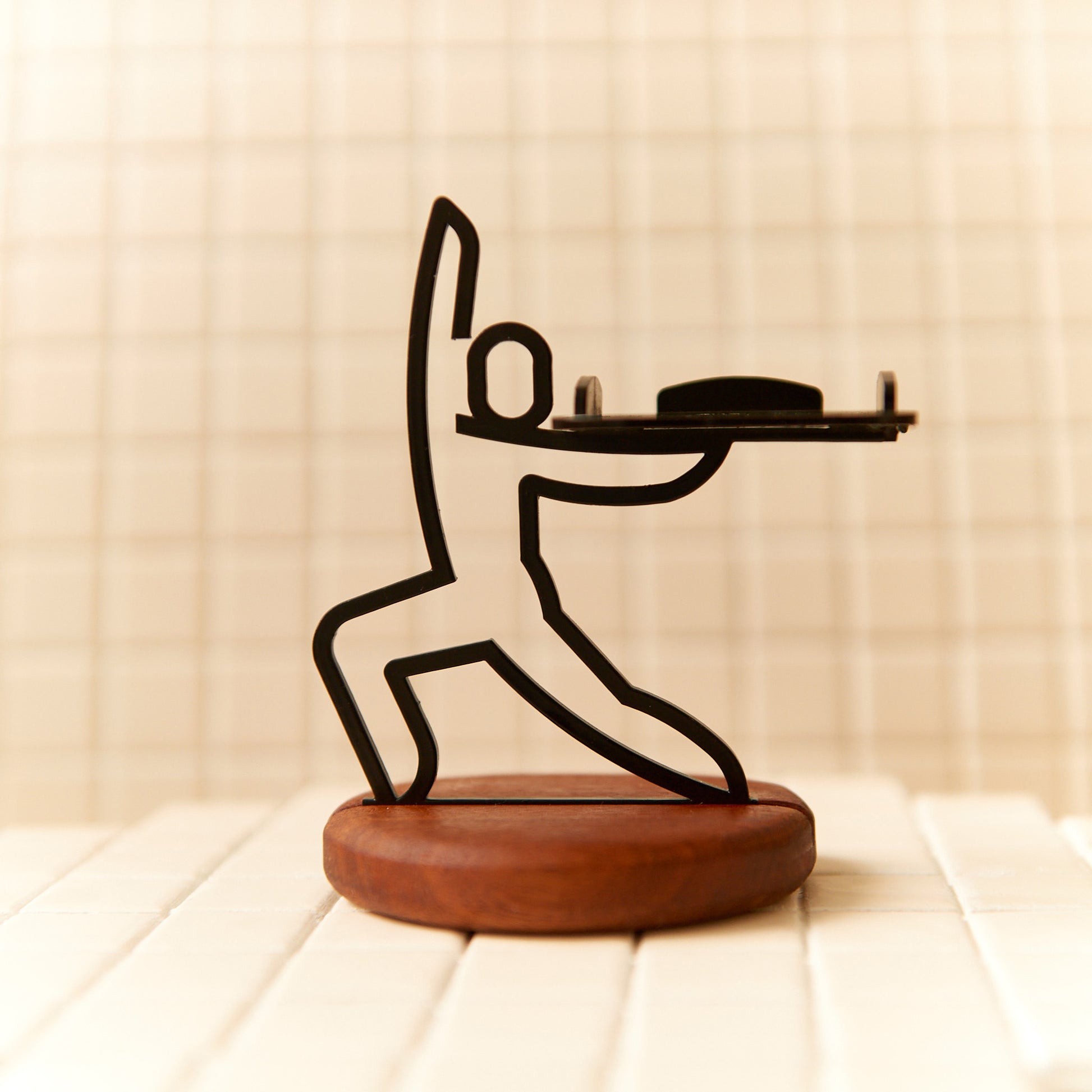 Metal Warrior Pose sculpture on mahogany base, handcrafted art for yoga studios.