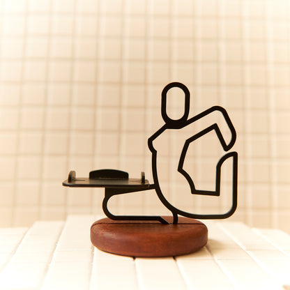 Handcrafted Mermaid Pose candle holder made of metal and mahogany, symbolizing grace and balance.