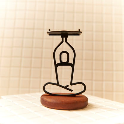 Handcrafted Lotus Pose Raised Arms candle holder with metal body and mahogany base.