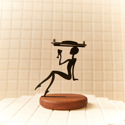 Handmade extraterrestrial candle holder with wooden base and sleek black silhouette design.