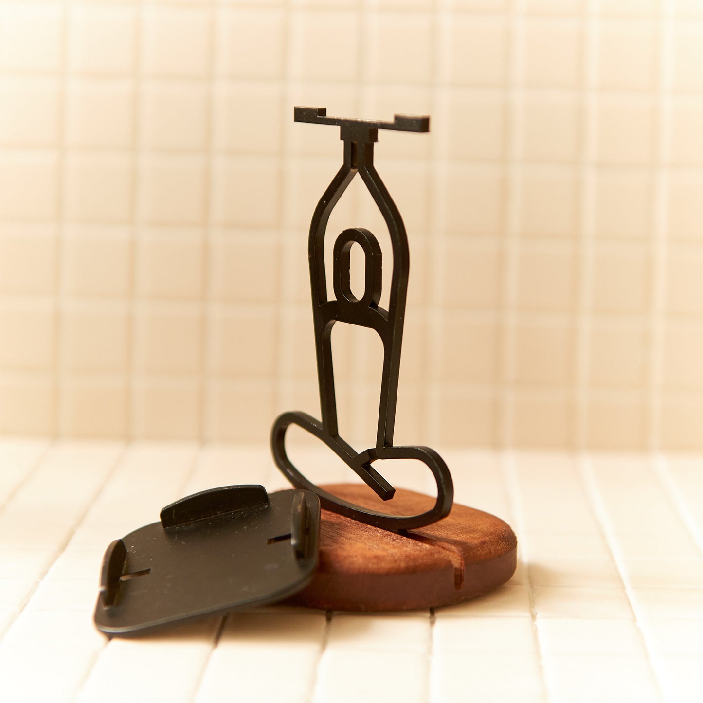 Close-up of Lotus Pose candle holder, handcrafted from metal and wood.