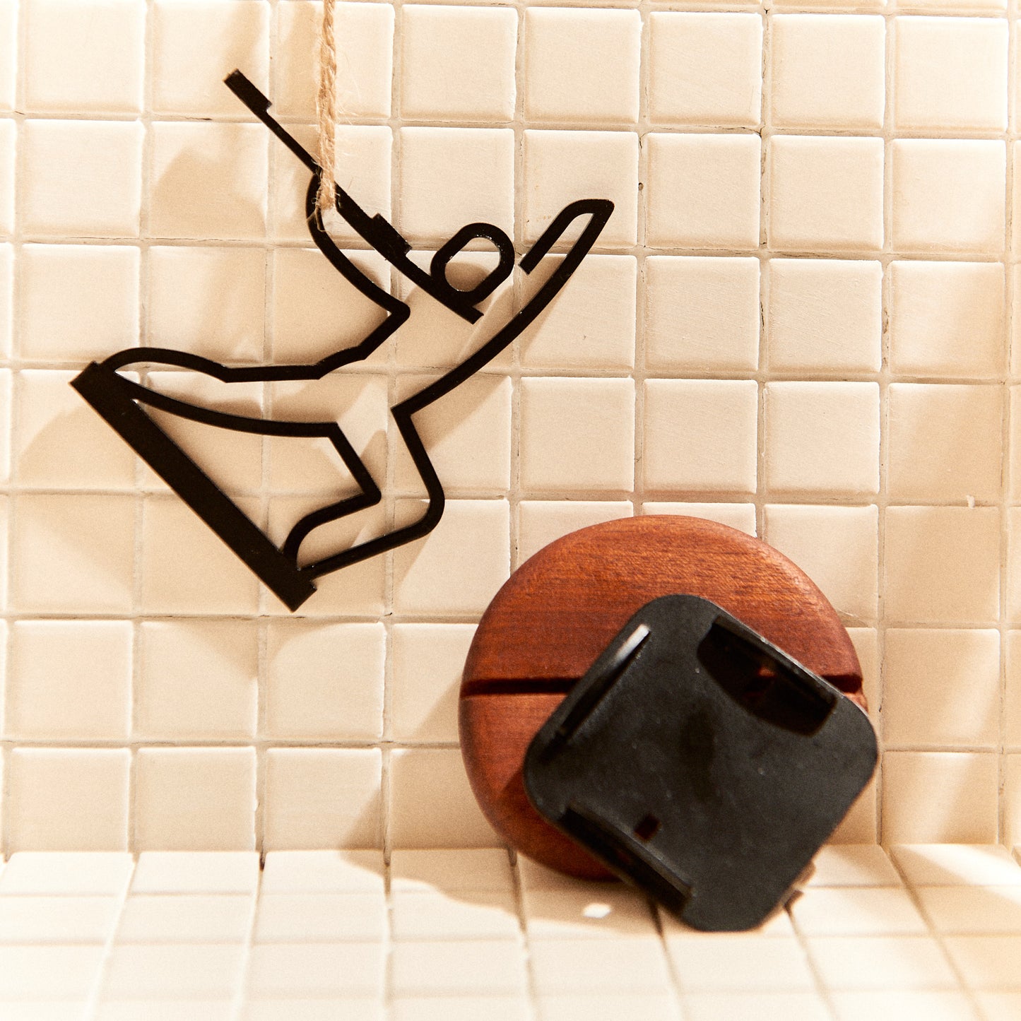 Close-up of Warrior Pose candle holder, metal figure with wood base, boho home decor.