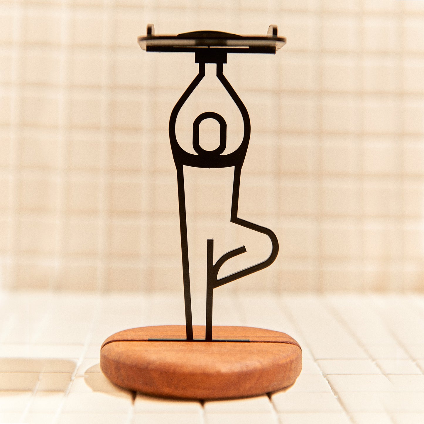 Handcrafted Tree Pose candle holder made of metal and mahogany, symbolizing grounding and balance.