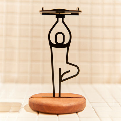 Handcrafted Tree Pose candle holder made of metal and mahogany, symbolizing grounding and balance.
