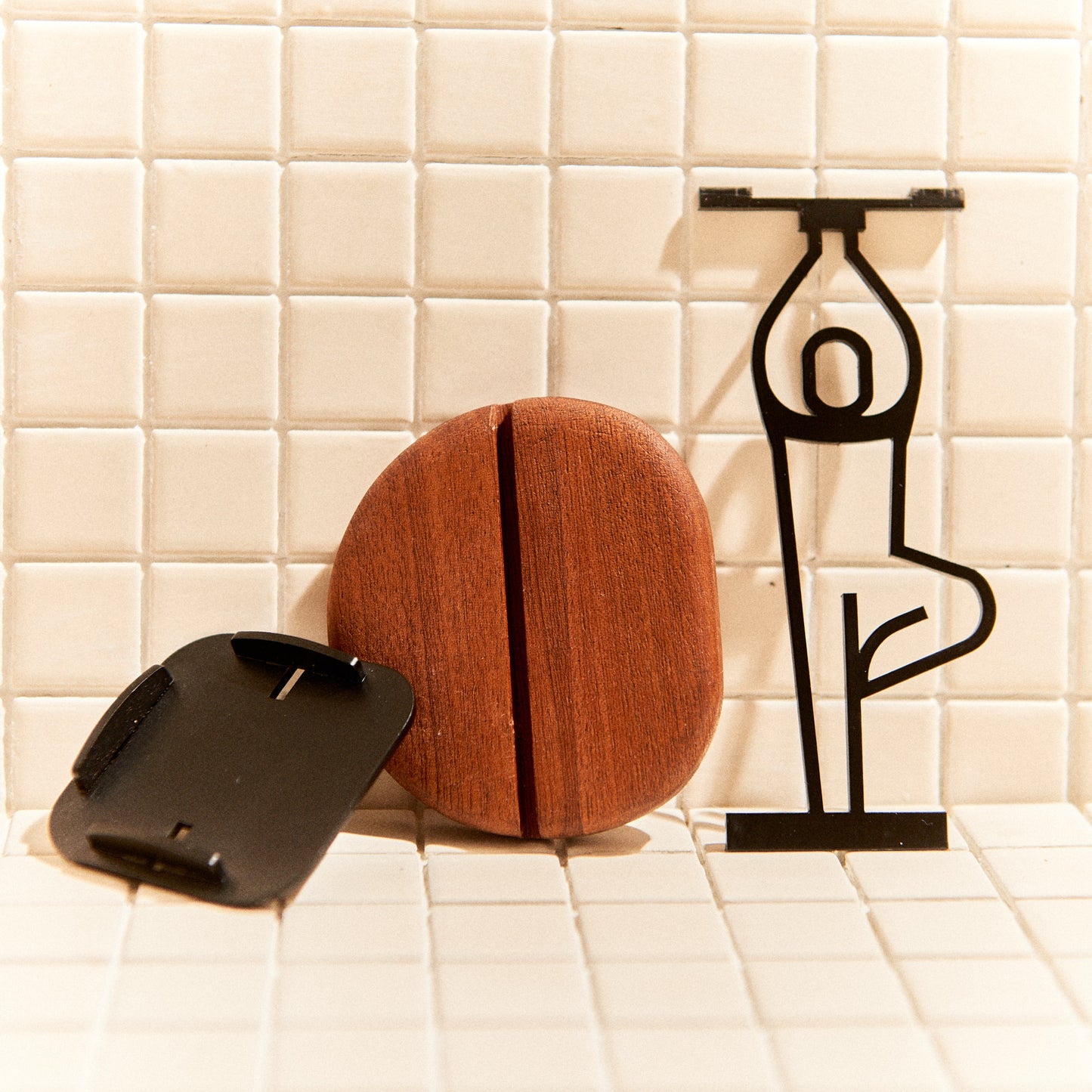 Close-up of Tree Pose candle holder, metal figure with wood base, boho decor.