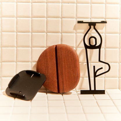 Close-up of Tree Pose candle holder, metal figure with wood base, boho decor.