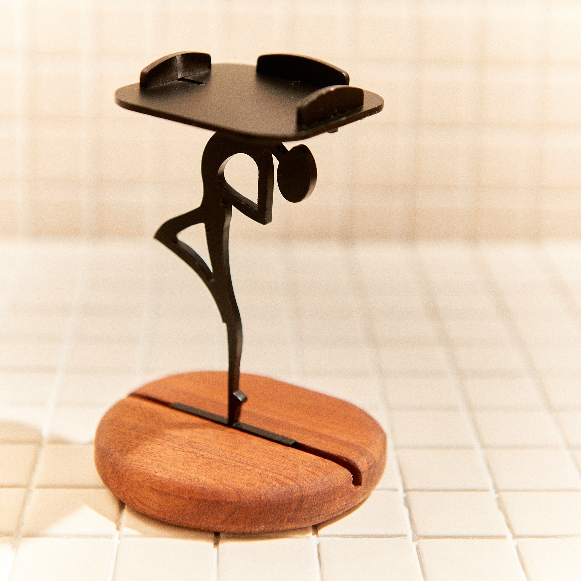 Minimalist alien-shaped candle holder gazing upward, handmade decor.