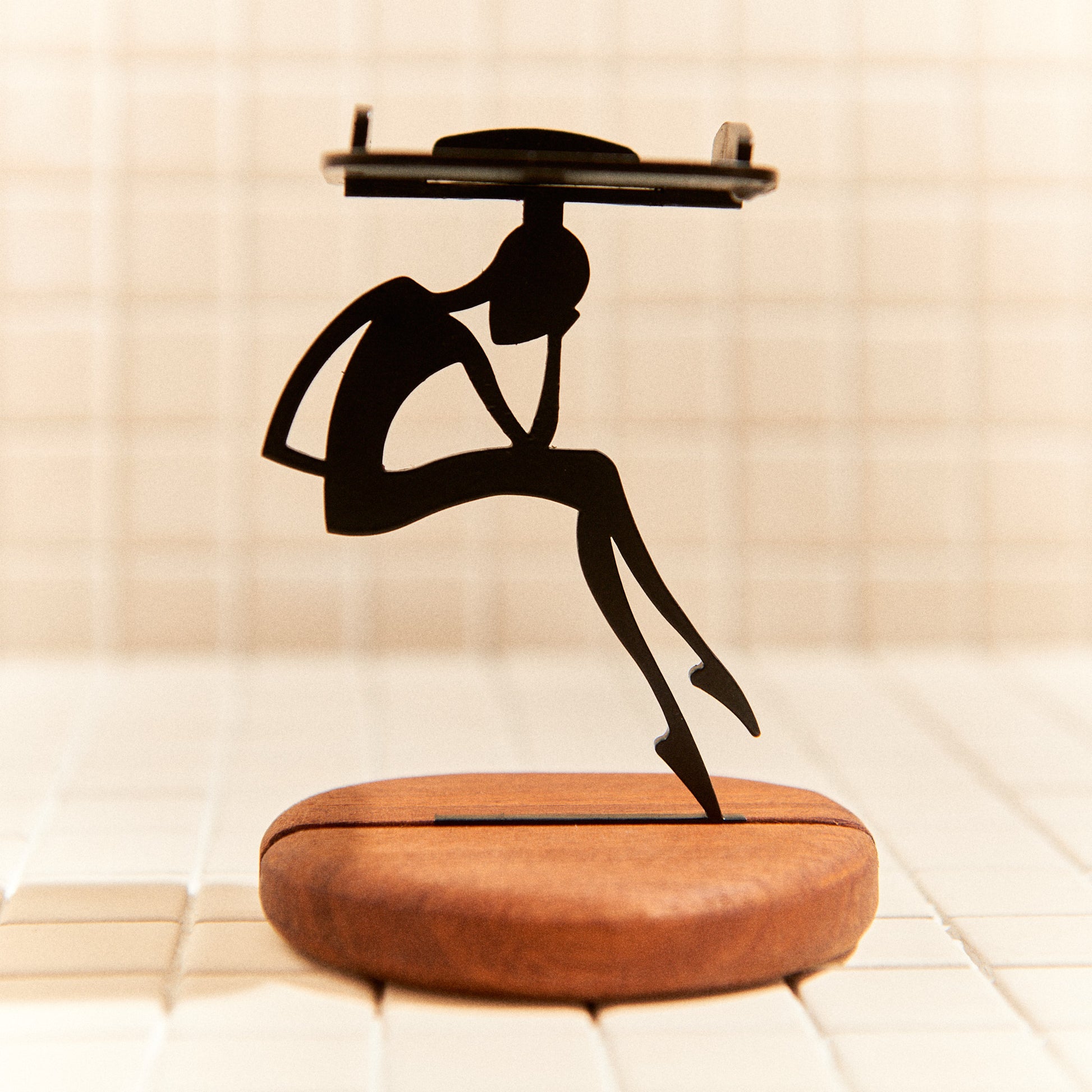 Minimalist alien sculpture sitting in deep thought, handmade decor.