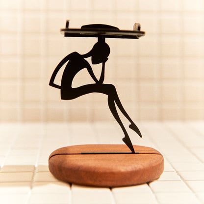 Minimalist alien sculpture sitting in deep thought, handmade decor.