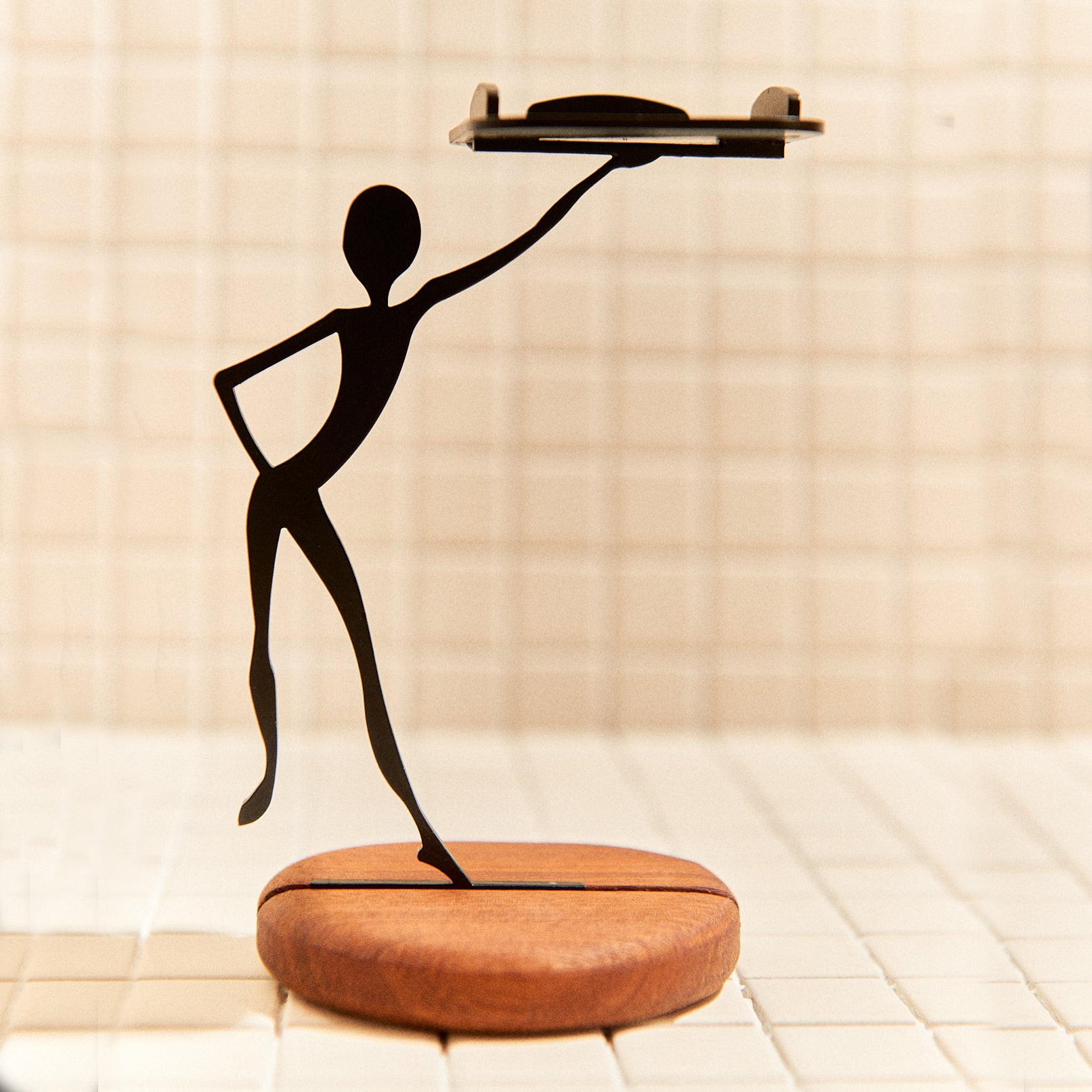 Handcrafted alien gesture candle holder made of metal and mahogany.