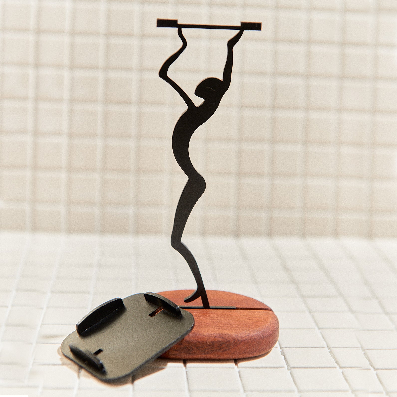 Stylish alien candle holder displayed in cozy interior – handmade metal and mahogany decor inspired by cosmic design.