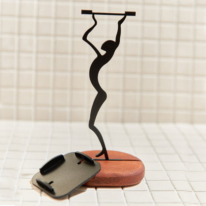 Stylish alien candle holder displayed in cozy interior – handmade metal and mahogany decor inspired by cosmic design.