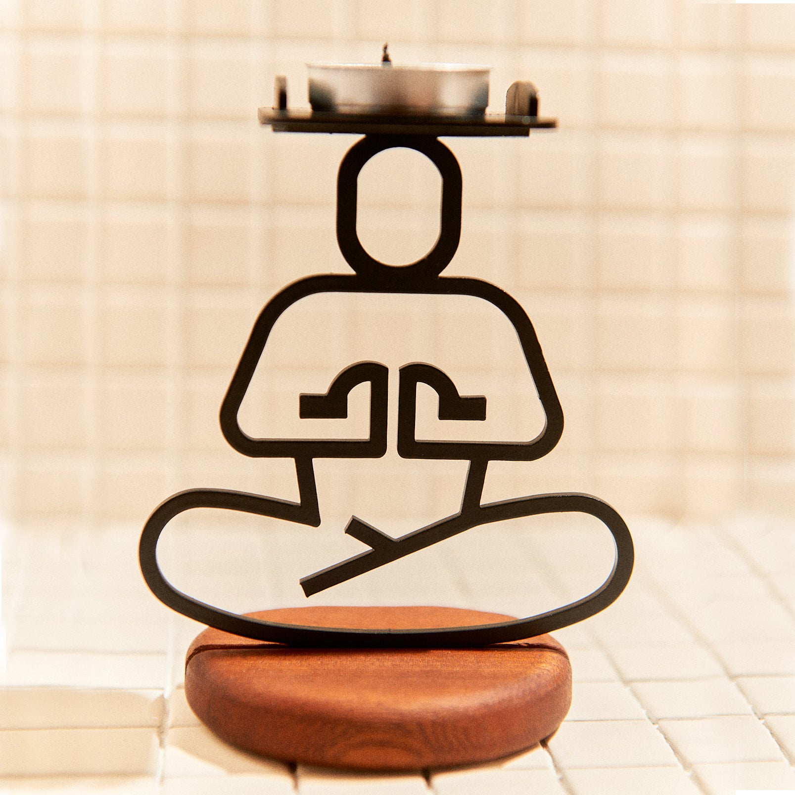 Yoga candle holder in Ardha Lotus pose with tealight on head, minimalist handmade decor.