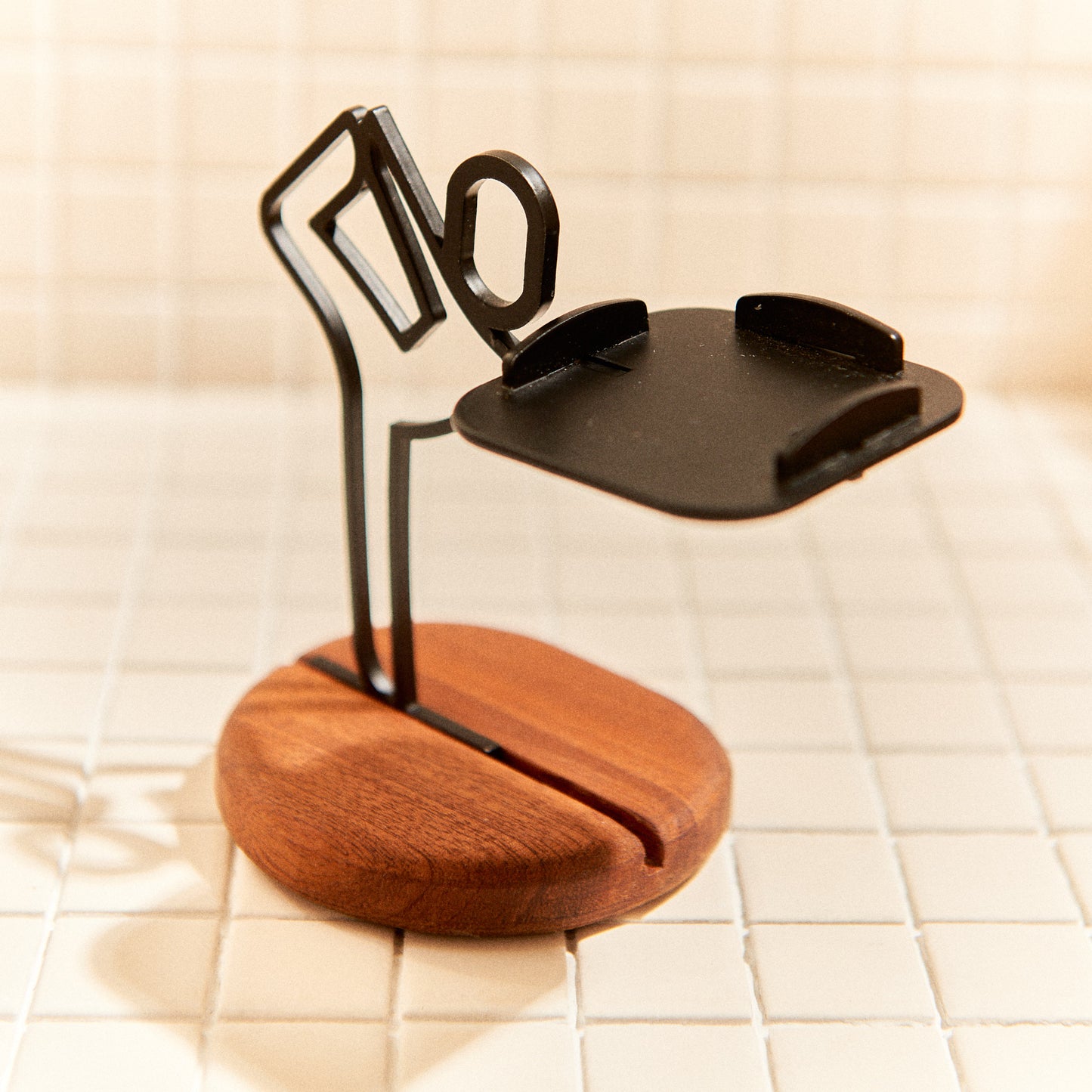 Metal Baby Dancer sculpture candle holder on mahogany base, perfect for yoga spaces.