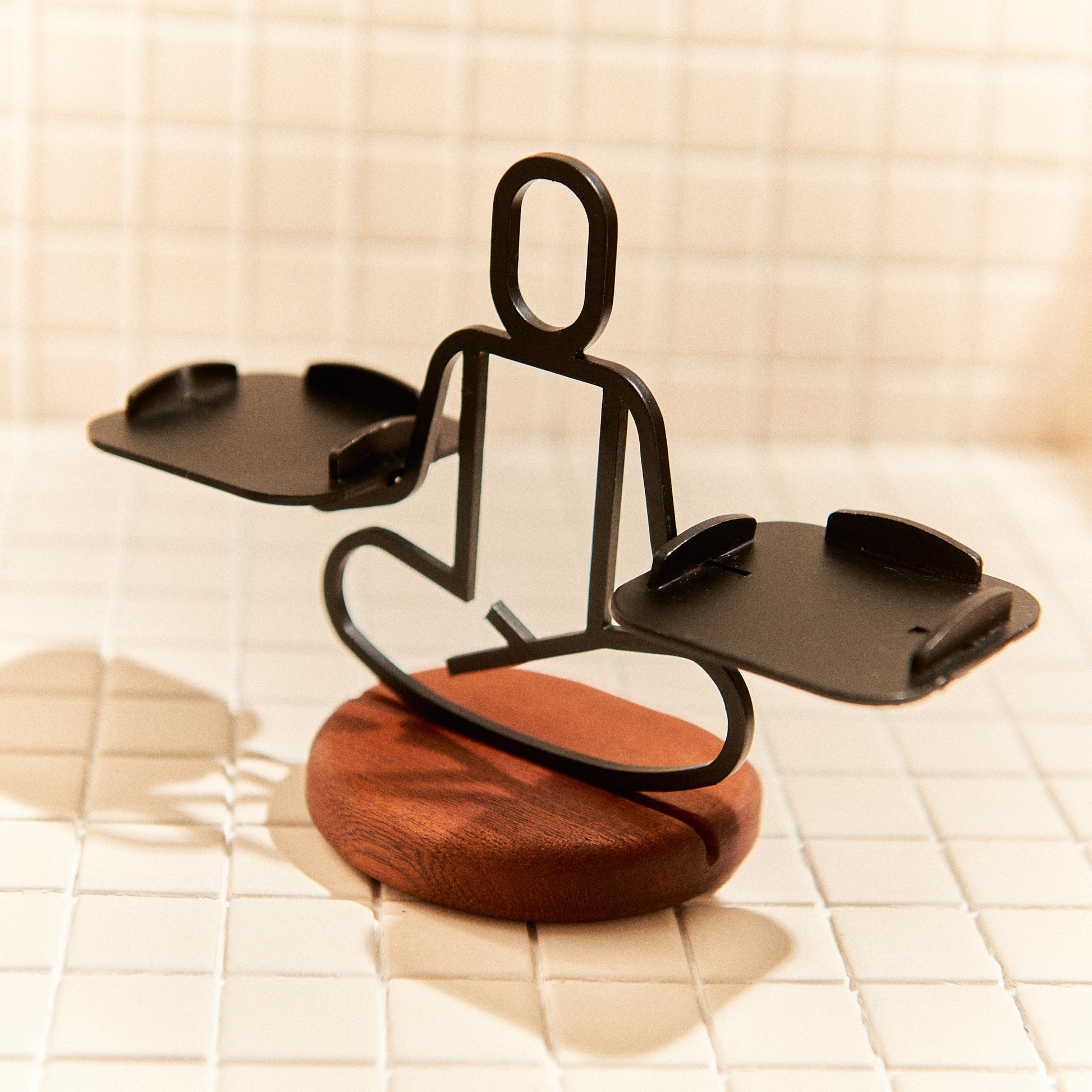 Metal Half Lotus Pose sculpture on mahogany base for yoga or meditation spaces.